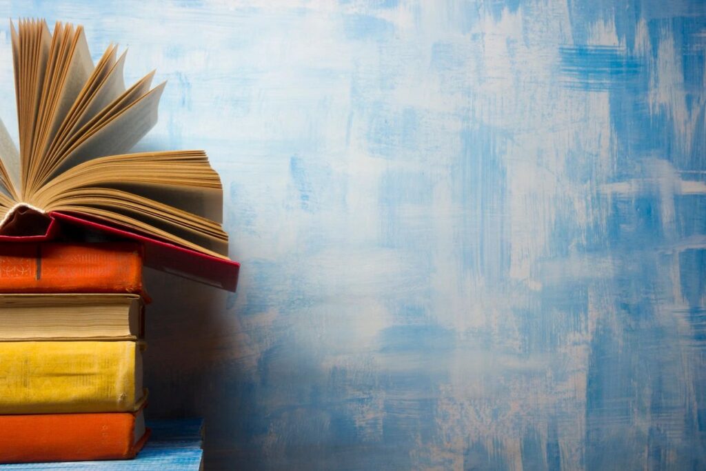 Stack of Books Against a Blue Wall