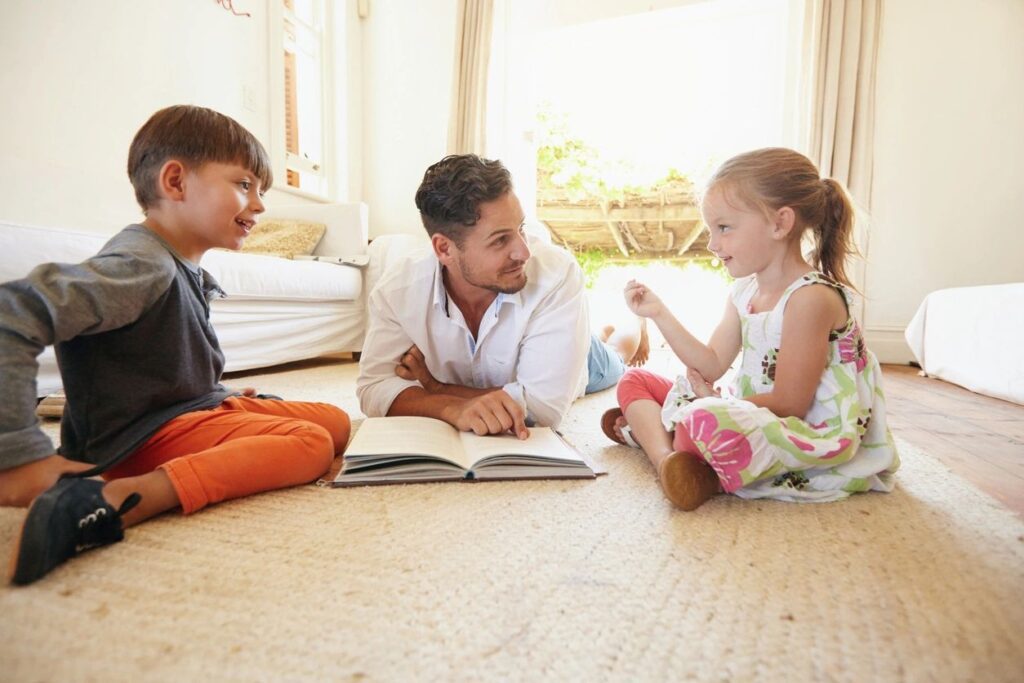 A Father Reading a Chapter Book to His Two Children