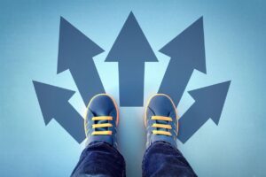 Blue Shoed Child's Feet Standing on Arrows Points in All Different Directions