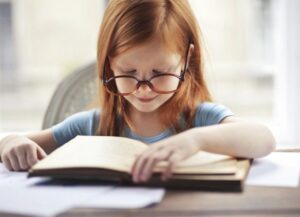 Young Girl Reading a Chapter Book