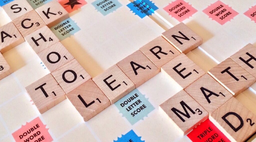 Scrabble Letters Positioned to Spell School To Learn Read and Math