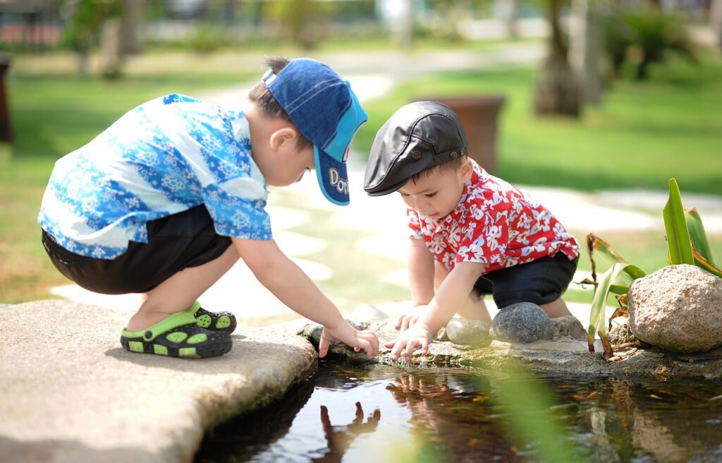 boys playing in a pond